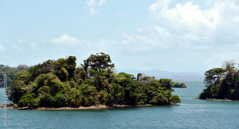 Green landscape of Panama Canal, view from the transiting cargo ship. Green landscape of Panama Canal, view from the transiting cargo ship.