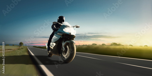 Rapid motorbike ride on the country road at the most beautiful sunset. Adventure and motor sport. © Olaf Simon