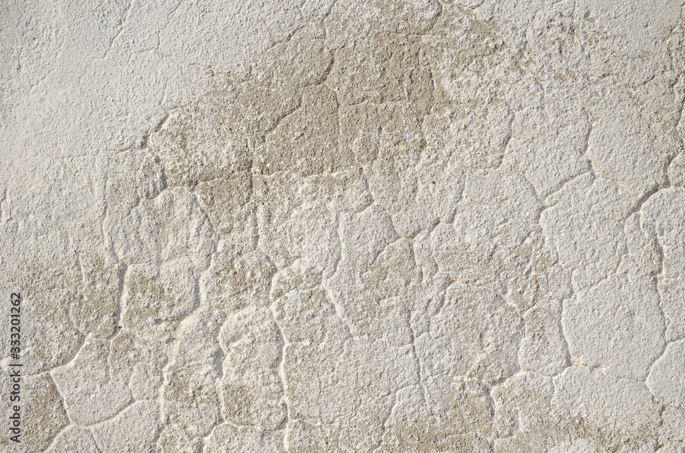 gray wall of old house closeup. White peeling plaster. Cracks on the surface of building or fence. City building concept. Copy space. Place for text. Selective focus image. gray wall of old house closeup. White peeling plaster. Cracks on the surface of building or fence. City building concept. Copy space. Place for text. Selective focus image.