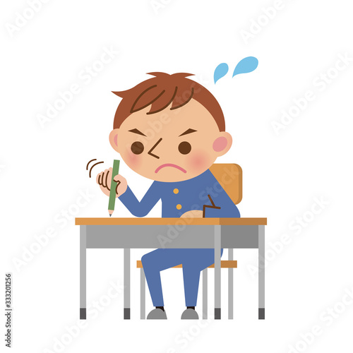 教室の机で必死に勉強する男子中学生・高校生