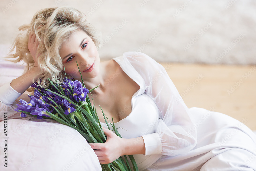 Attractive young woman portrait. Beautiful lady indoors. Female holding flowers. Attractive young woman portrait. Beautiful lady indoors. Female holding flowers.