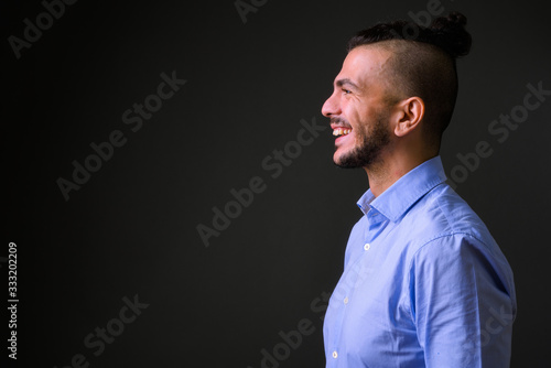 Closeup profile view of happy bearded Turkish businessman smiling