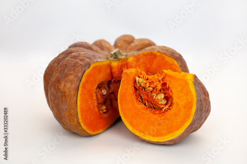 Orange pumpkin cutaway on a white background, farm organic vegetables
