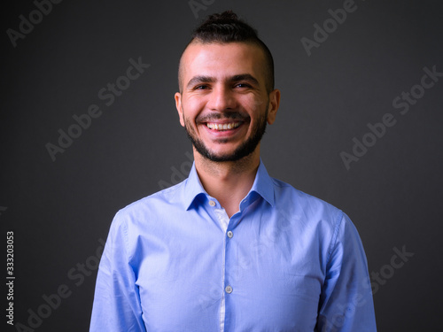 Face of happy bearded Turkish businessman looking at camera