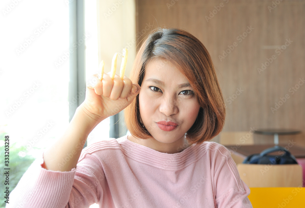 custom made wallpaper toronto digitalA woman smiling and using the French fries to act like a wolf's claw,Selective focus