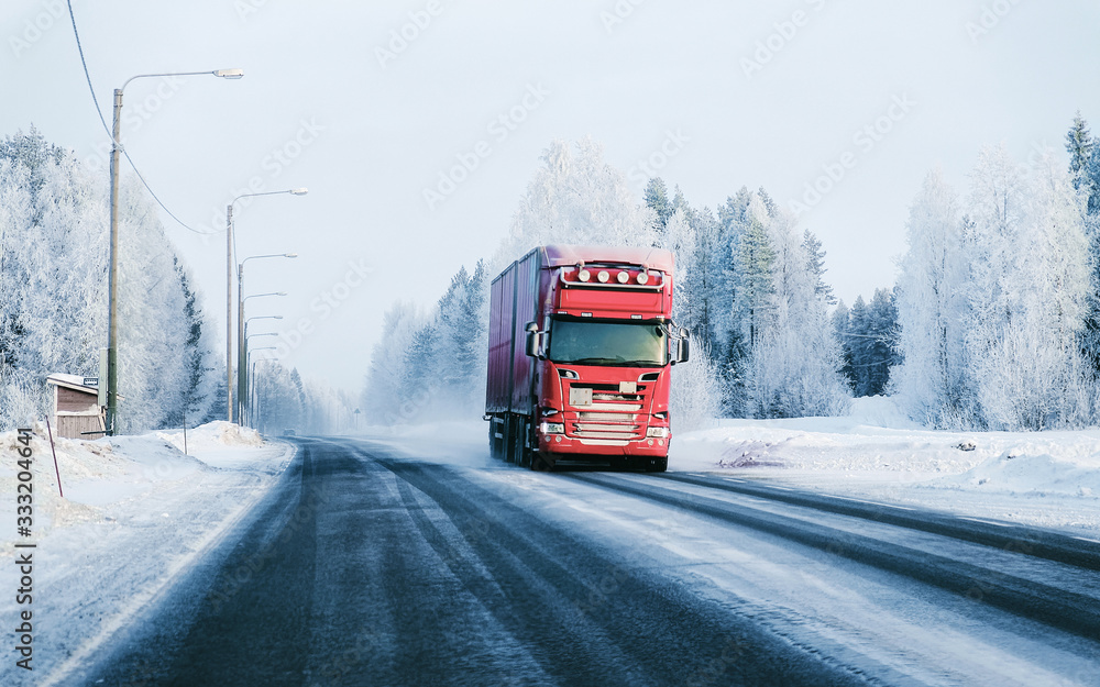 Truck at the Snowy winter Road in Finland Lapland reflex