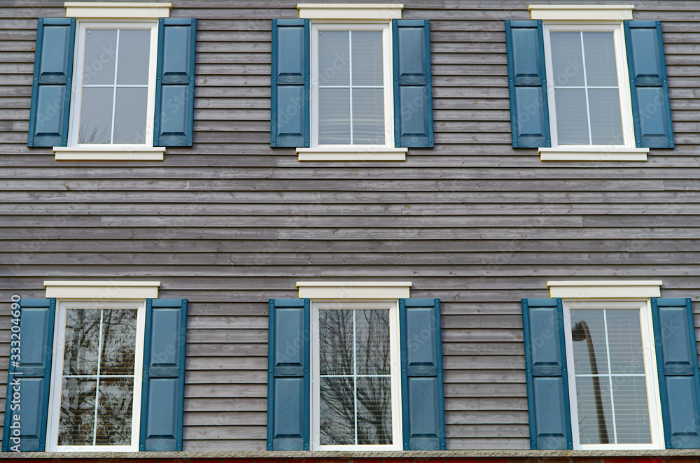 residential windows facade blue gray wood planks home building