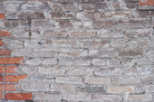 Old brick wall with cement lining. Rough brick walls. Cracked bricks. Background, material for design and modeling