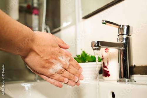 Fototapeta Naklejka Na Ścianę i Meble -  Corona Virus pandemic protection by washing hands frequently.
