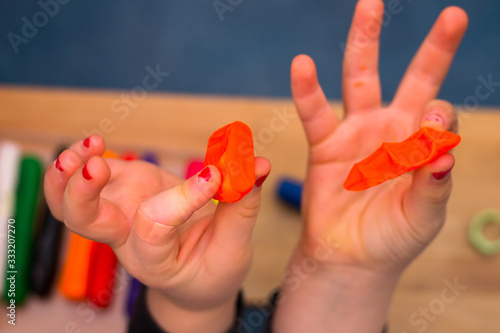 .child playing with plasticine and making molds photo