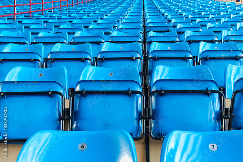 empty bleachers and chairs in blue