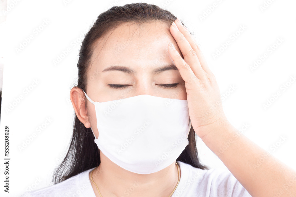 Closeup woman wearing face mask for protect air polution or virus covid 19 with headache on background, health care and medical concept Closeup woman wearing face mask for protect air polution or virus covid 19 with headache on background, health care and medical concept