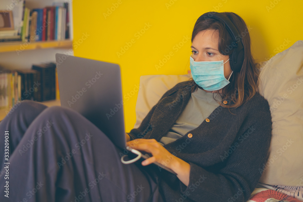 A white girl is working from home during Coronavirus or Covid-19 quarantine, coronavirus covid 19 infected patient in coronavirus covid 19 quarantine room using computer A white girl is working from home during Coronavirus or Covid-19 quarantine, coronavirus covid 19 infected patient in coronavirus covid 19 quarantine room using computer