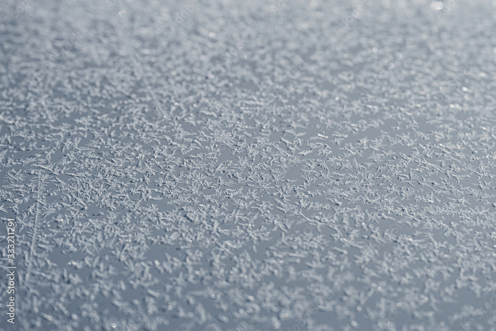 Tiny snowflakes on the car bonnet