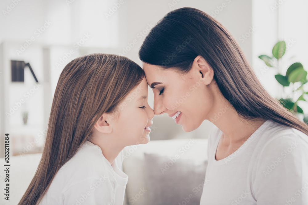Profile photo of pretty little girl leaning heads young charming mommy affection feelings comfortable atmosphere spend time together eyes closed overjoyed home house indoors Profile photo of pretty little girl leaning heads young charming mommy affection feelings comfortable atmosphere spend time together eyes closed overjoyed home house indoors