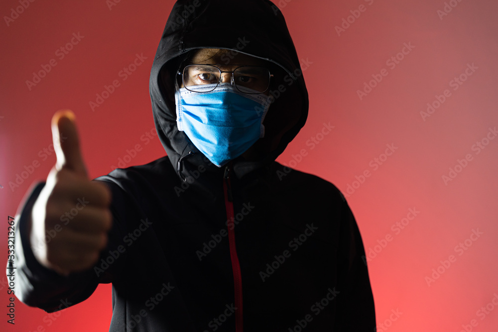 Asian man wearing a hood and mask Make a thumbnail of good protect Covid 19 Asian man wearing a hood and mask Make a thumbnail of good protect Covid 19