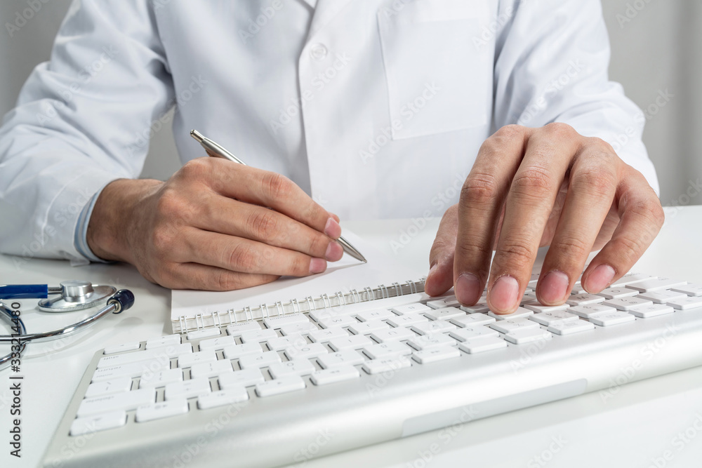Doctor typing on wireless computer keyboard Doctor typing on wireless computer keyboard