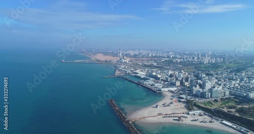 Israel skyline from a drone. Panoramic Aerial view above coastline of Tel Aviv modern and business city with hotels, seashore and beach. Middle east skylines
