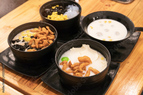 Kind of cold and hot dessert; Cold assorted beans in syrup, Soybean curd in soy milk with small bread stick and Rainbow glutinous rice balls in coconut milk.