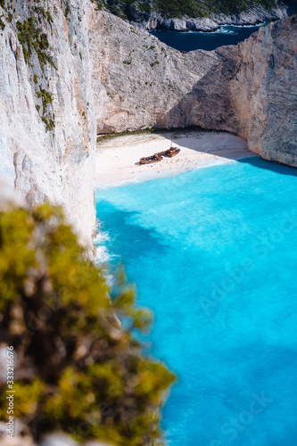 Shipwreck on Navagio beach. Azure turquoise sea water and paradise sandy beach. Famous tourist visiting landmark on Zakynthos island, Greece photo