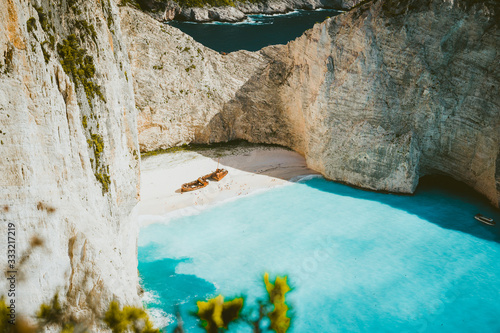 Famous shipwreck of Navagio beach with turquoise blue sea water surrounded by huge white limestone cliffs. Famous landmark location on Zakynthos island, Greece