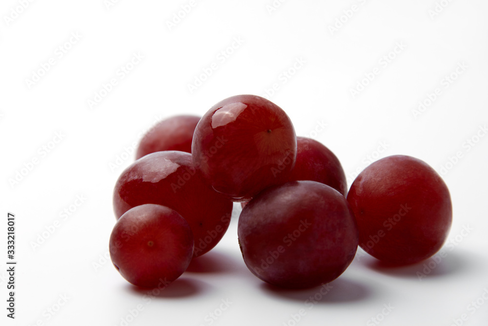 Red grape berries on a white background