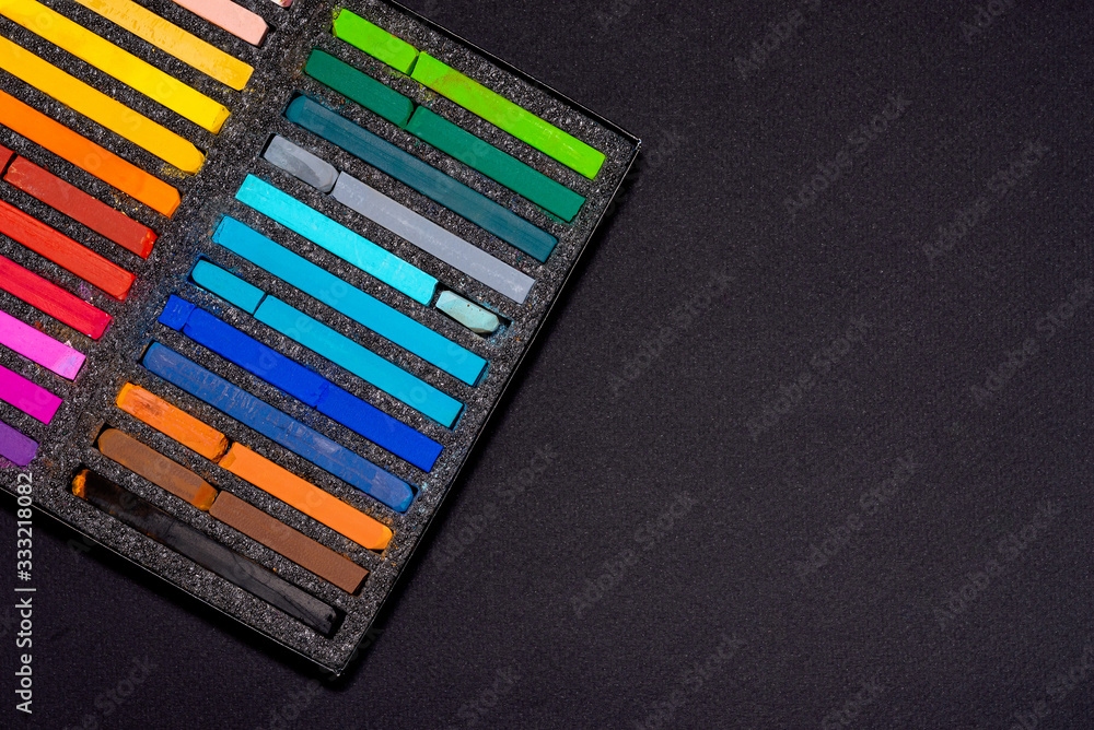 pastel crayons for drawing in a black box on a black background pastel crayons for drawing in a black box on a black background