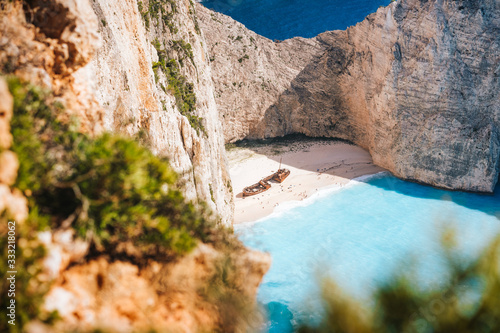 Famous shipwreck on Navagio beach. Blue sea cove surrounded by huge white limestone cliffs. Famous landmark location on Zakynthos island, Greece