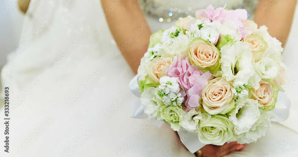 Bride in wedding dress holding flower bouquet Bride in wedding dress holding flower bouquet