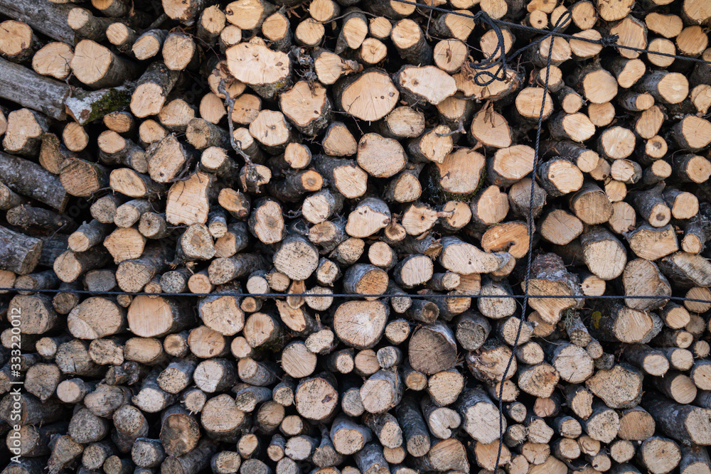 Firewood storage concept. Natural sawn wood stacked in row, texture. Stacks of chopped logs as background. Wallpaper. Firewood storage concept. Natural sawn wood stacked in row, texture. Stacks of chopped logs as background. Wallpaper.