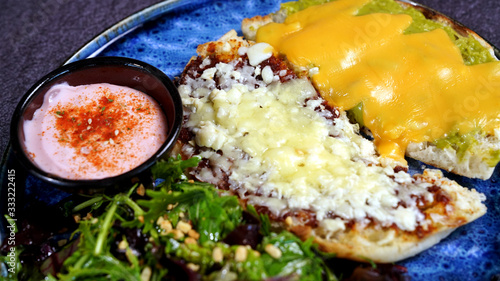 A nice breakfast plate with cheddar cheese, onion and tomato sauce