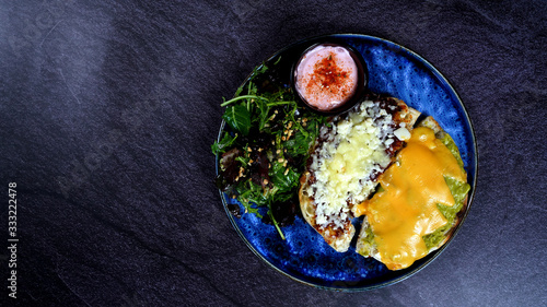 A nice breakfast plate with cheddar cheese, onion and tomato sauce