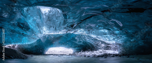 Inside an ice cave in Vatnajokull, Iceland, the ice is thousands of years old and so packed it is harder than steel and crystal clear. Winter travel around the world. Beautiful landscape background