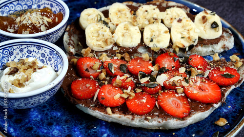 Waffles combined with Turkish delicacies are strawberries, bananas, honey, milk cream.