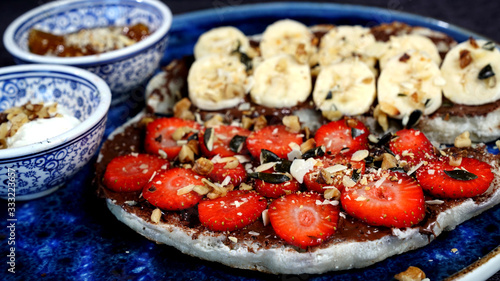 Waffles combined with Turkish delicacies are strawberries, bananas, honey, milk cream.