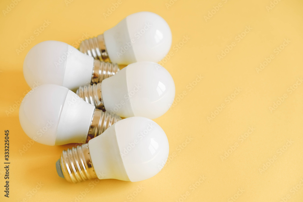 LED light bulbs on yellow background. Top view. Copy, empty space for text LED light bulbs on yellow background. Top view. Copy, empty space for text