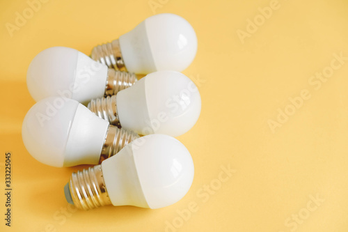 LED light bulbs on yellow background. Top view. Copy, empty space for text