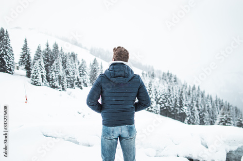 man standing and looking mountains