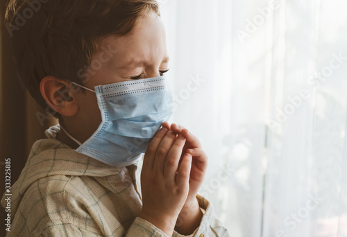 Coronavirus covid-19. Child praying to God requesting that the coronavirus covid 19 not spread beyond control.  © Анастасія Стягайло