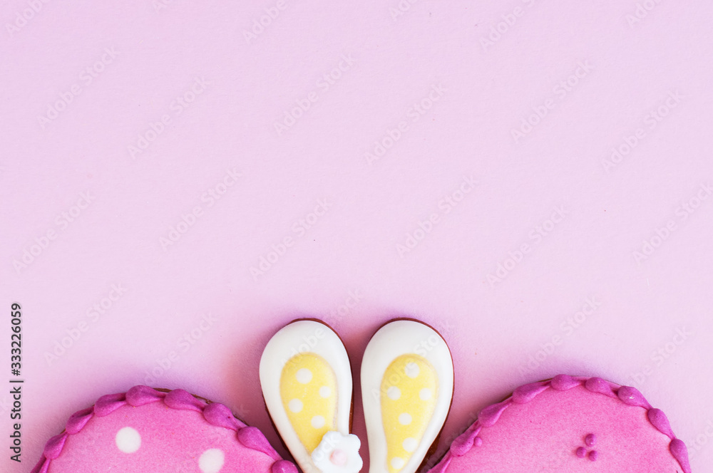  Polka dot easter egg and bunny ear cookies on a pink background.