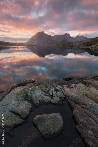 View of a norwegian fjord in summer on Senja island in northern Norway, beautiful landscape Tromso country Colorful sunset, midnight sun during summer holidays.