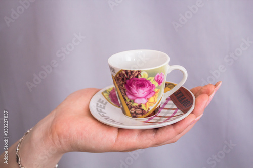 Girl holds a cup of coffee