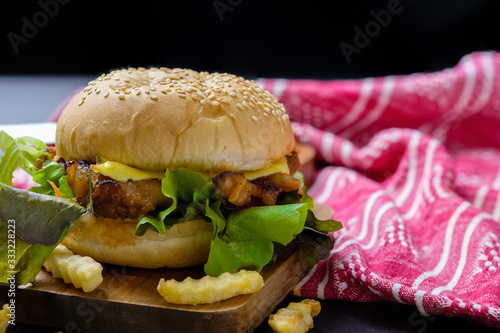 Homemade hamburger with cheese and fresh vegetables.