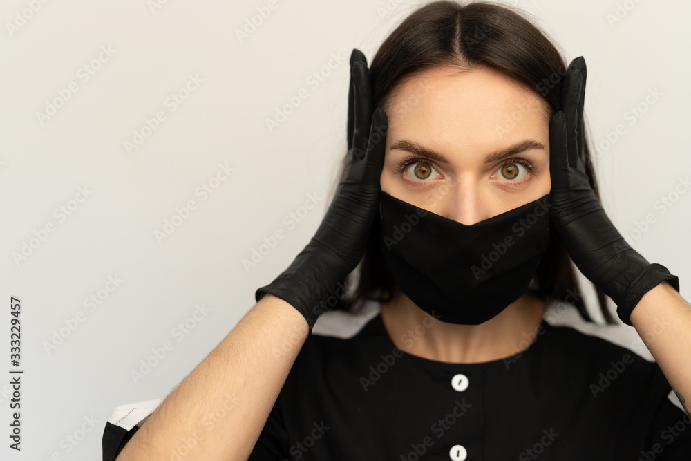 Coronavirus, a young girl in a black protective mask and black gloves, dressed in black clothes Coronavirus, a young girl in a black protective mask and black gloves, dressed in black clothes
