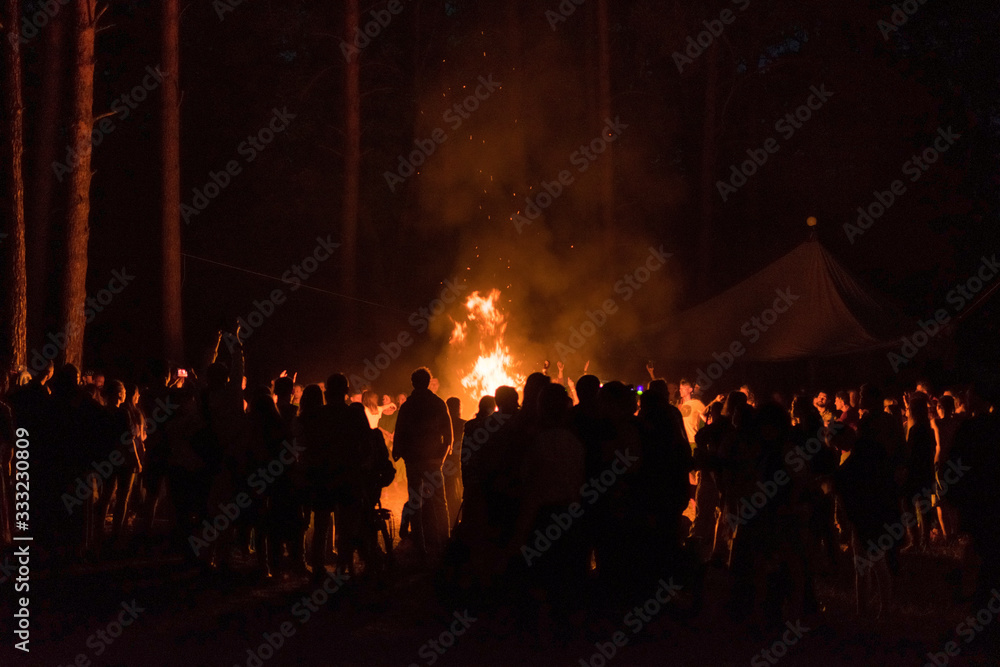 Kiev, Ukraine, - June 03, 2018: A lot of people around the fire at night at the festival.