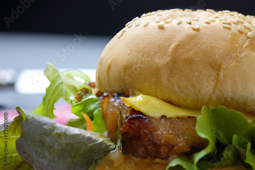 Homemade hamburger with cheese and fresh vegetables.