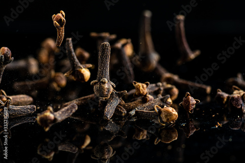 a lot of dried clove seeds on a dark background photo