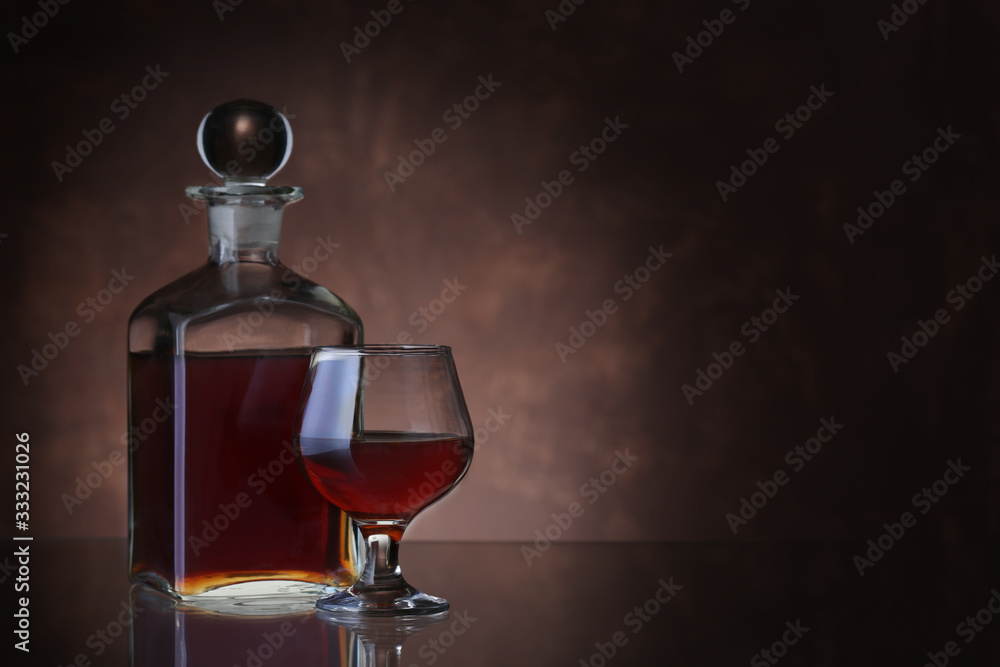 Bottle of whiskey and glass on brown background Bottle of whiskey and glass on brown background