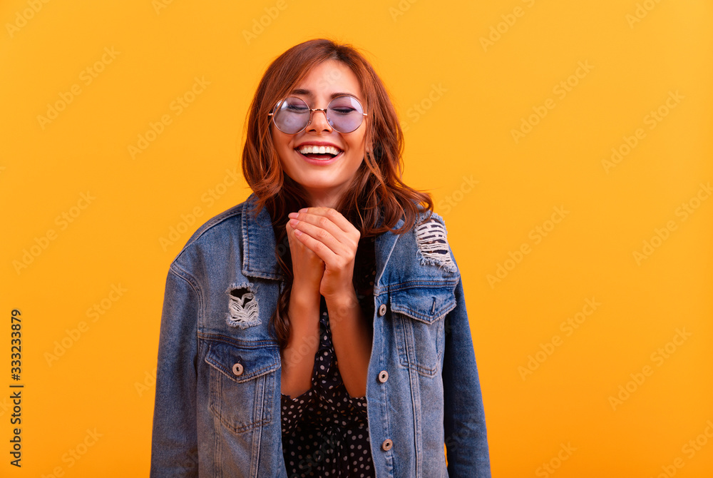 Red hair curly girl in jeans coat and dress excited and glad to achieve victory, clenches fists, screams in excitement with closed eyes, happy to pass all exams at university, successful person. Red hair curly girl in jeans coat and dress excited and glad to achieve victory, clenches fists, screams in excitement with closed eyes, happy to pass all exams at university, successful person.
