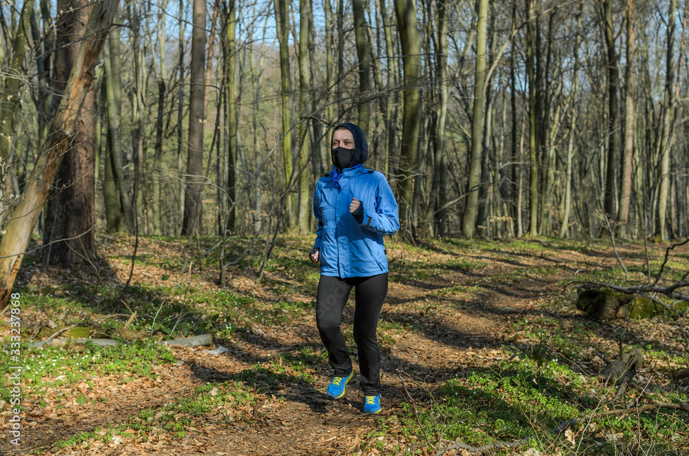 Young girl in a mask runs in the forest Young girl in a mask runs in the forest
